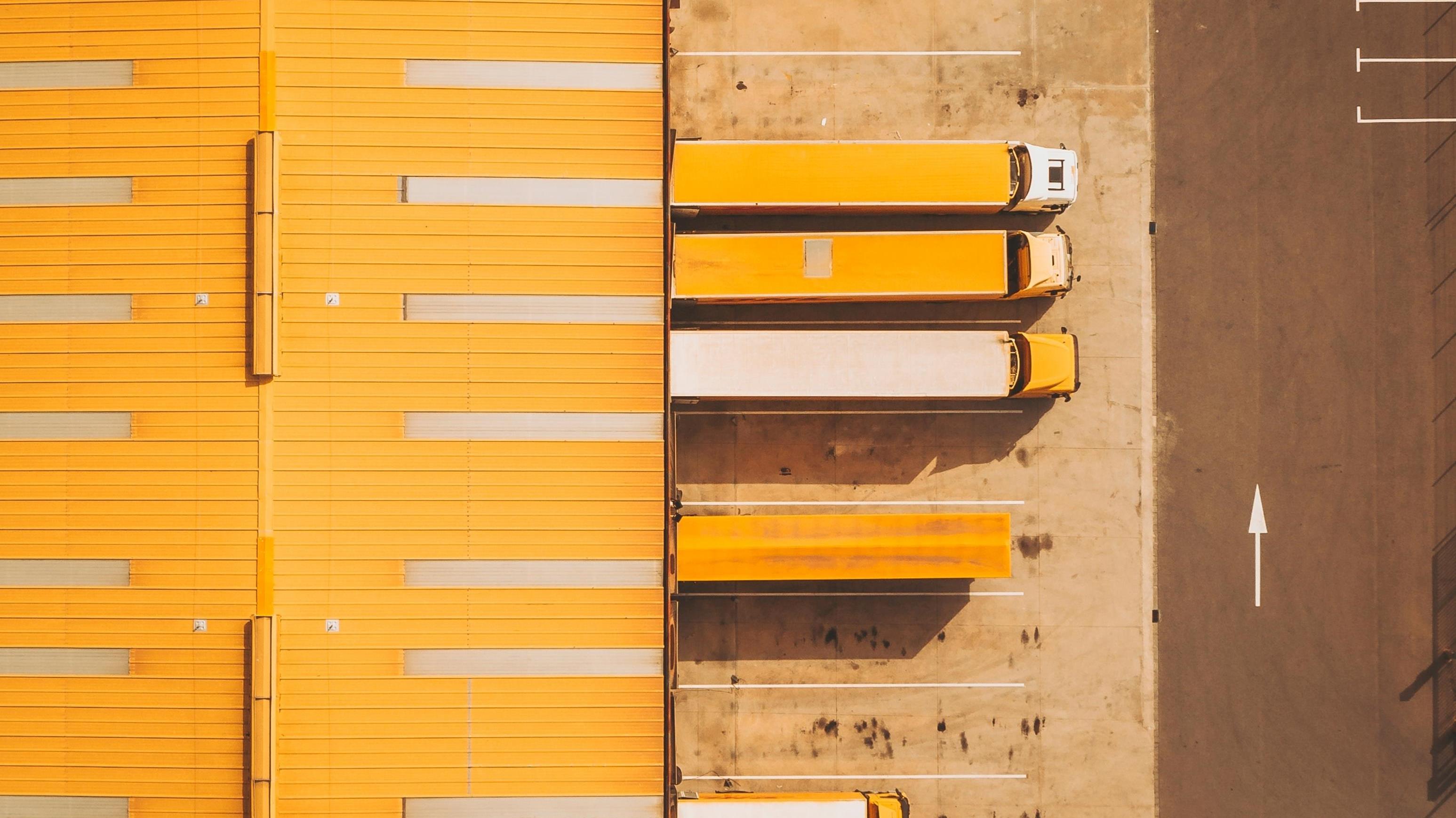 Aerial view of trucks at industrial warehouse loading docks